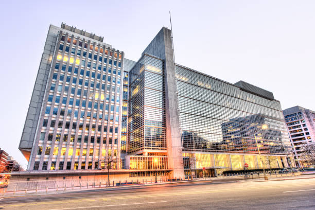 world bank group headquarters entrance modern glass building with street during evening sunset