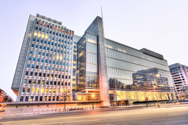 World Bank Group headquarters entrance, modern glass building with street during evening sunset Washington Dc: World Bank Group headquarters entrance, modern glass building with street during evening sunset washington pennsylvania stock pictures, royalty-free photos & images