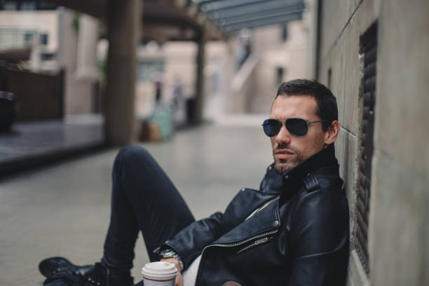 istock Man sitting on the sidewalk 817705858