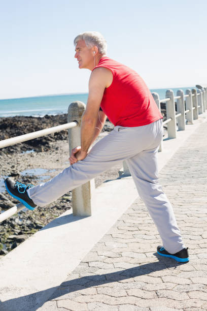 istock Fit mature man warming up on the pier 817710034