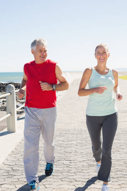 istock Fit mature couple jogging on the pier 817710810