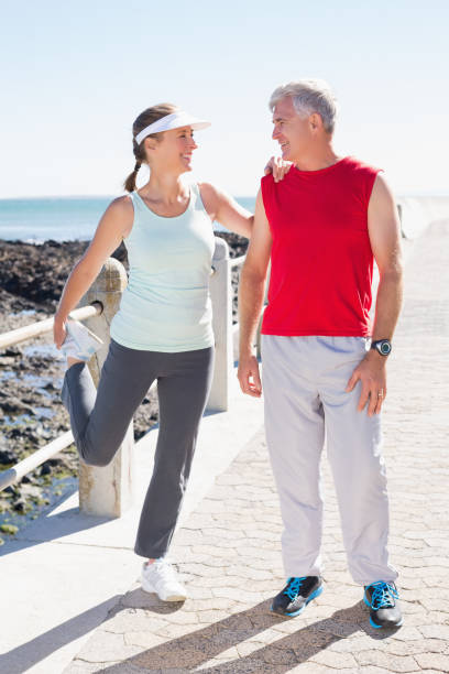istock Fit mature couple warming up together on the pier 817711526