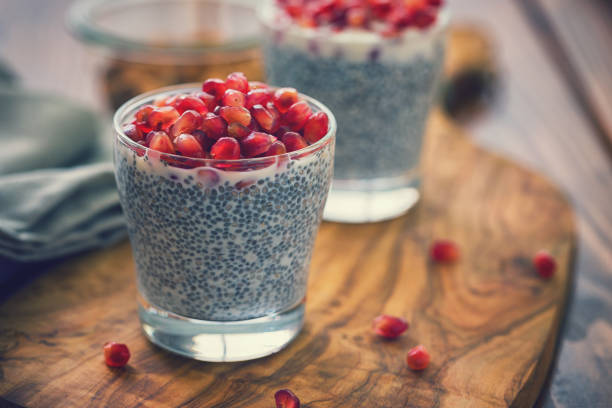 Chia Seed Pudding With Fresh Pomegranates Homemade fresh chia seed pudding with pomegranate seeds chia seed stock pictures, royalty-free photos & images