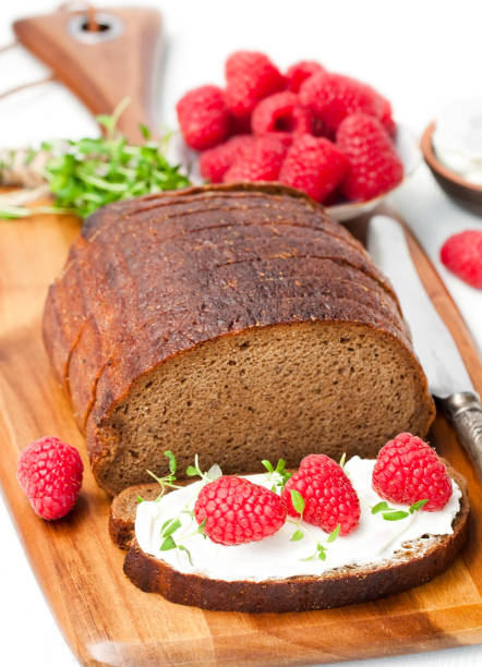 istock Traditional  black rye bread with raspberries and thyme and soft light cheese 817719196