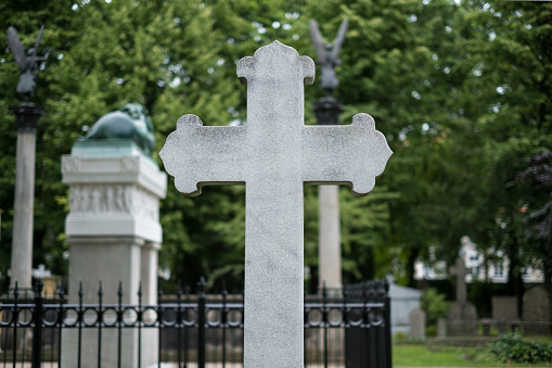 Stone cross gravestones on cemetery / graveyard