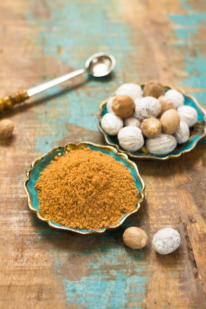 istock Nutmeg powder. Macro view whole nuts and grated muscat nuts. 817744934