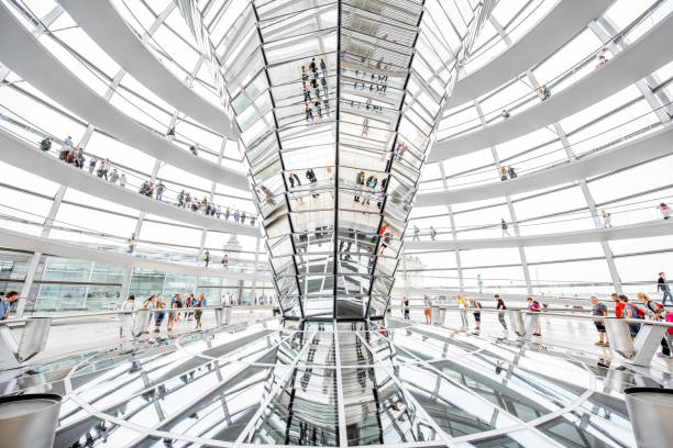 Reichstag builsing interior BERLIN, GERMANY - July 06, 2017: Interior view of famous Reichstag Dome with people in Berlin, Germany. It is one of Berlin's most important landmarks bundestag stock pictures, royalty-free photos & images