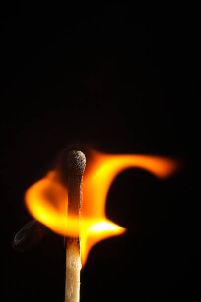 istock burning flame wooden match on black background 817750334