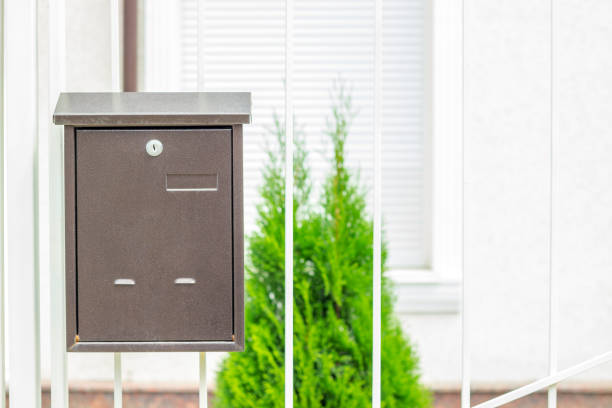 Mailbox on old classic iron doors. Traditional metal letterbox