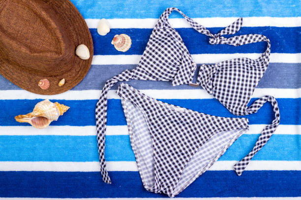 istock swimsuit with beach accessories on blue background 817771774
