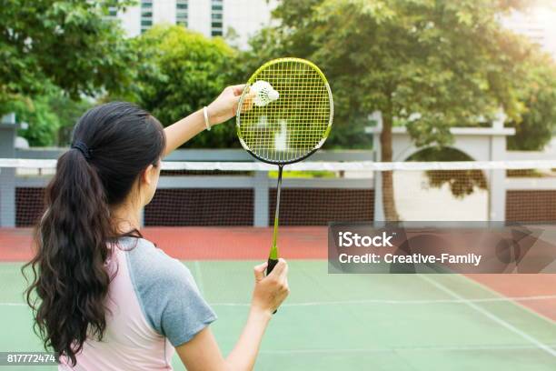 Girl Serving On A Badminton Match Outdoors Stock Photo - Download Image Now - Badminton - Sport, Outdoors, Sports Court