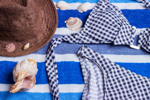 istock swimsuit with beach accessories on blue background 817772836
