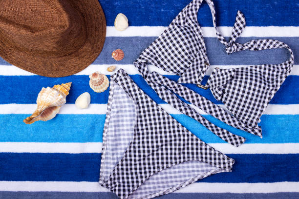 istock swimsuit with beach accessories on blue background 817773596