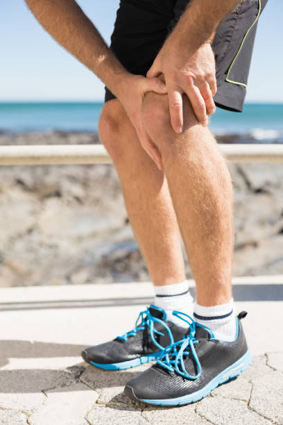 istock Fit man gripping his injured knee 817780688