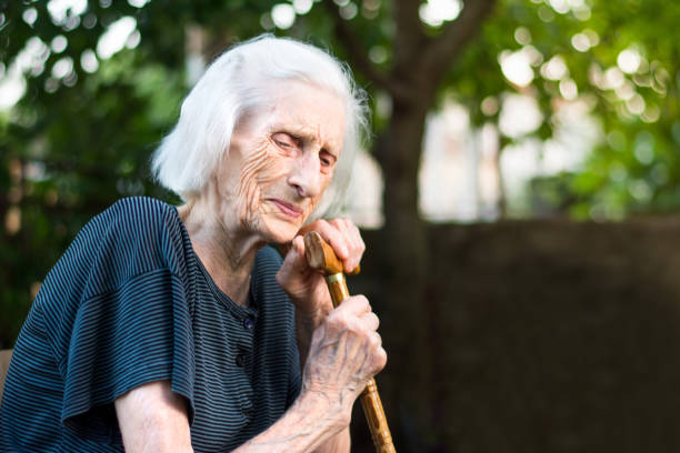 istock Senior woman crying with a walking cane 817781112