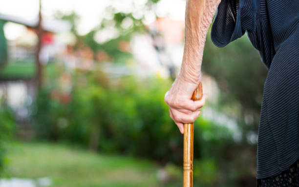 istock Senior woman walking with a cane 817782126