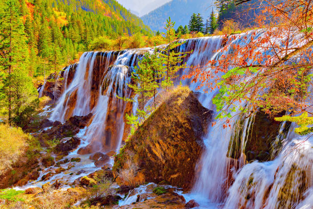 istock Autumn view of the waterfall with pure water. 817789792