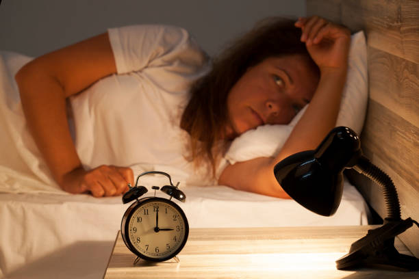 istock Woman lying in bed suffering from insomnia 817798878