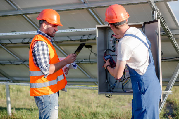 istock Worker and foreman cheking wires of solar panels. 817833406