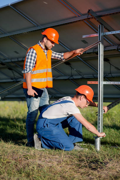 Builders installing frame with solar panels on helical pile. Builders installing frame with solar panels on helical pile. Engineers setting screw piles for solar power station. helical stock pictures, royalty-free photos & images