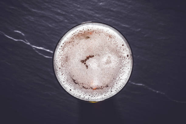 istock Beer glass on dark gray stone background. 817841874