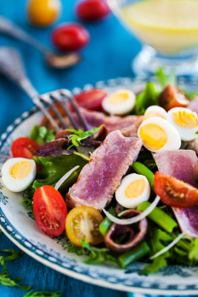 istock Tuna salad ( Nicoise) with tomatoes, boiled eggs, onion, anchovy and lettuce 817843180