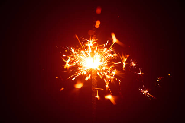 istock Christmas sparkler in haze with red light 817846996