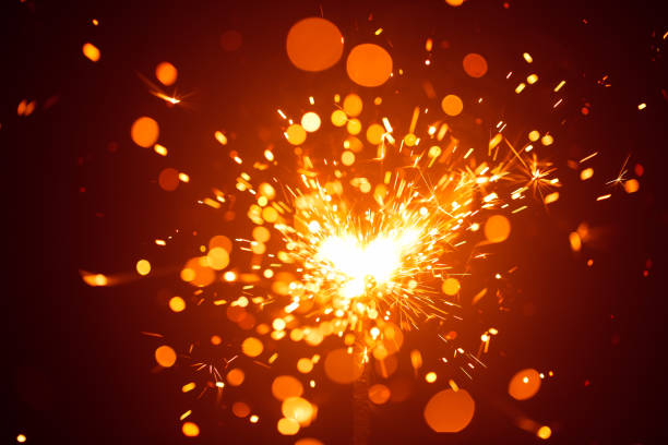 istock Christmas sparkler in haze with red light 817847056