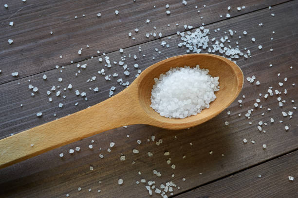 istock sea salt in a wooden spoon on a table 817847202