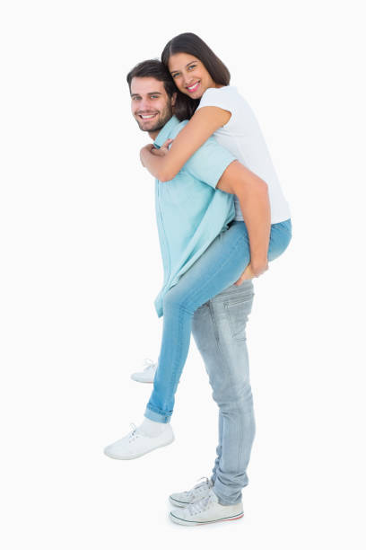 istock Happy casual man giving pretty girlfriend piggy back 817859444