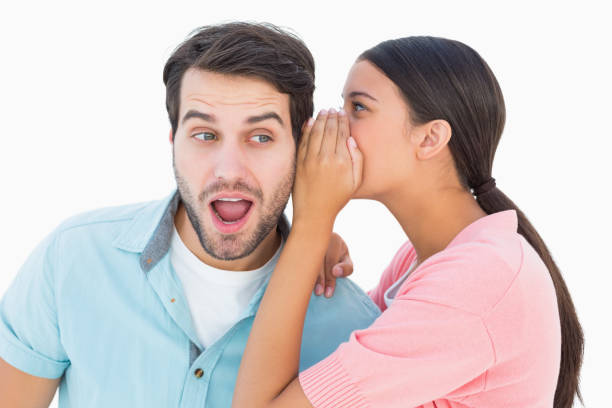 istock Brunette whispering secret to her boyfriend 817866598