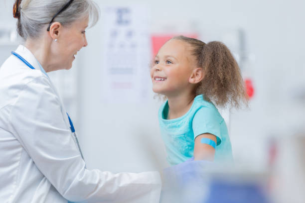 istock Caring doctor talks with young patient 817888760