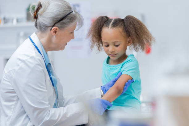 istock Doctor examines elementary age girl's arm 817888782