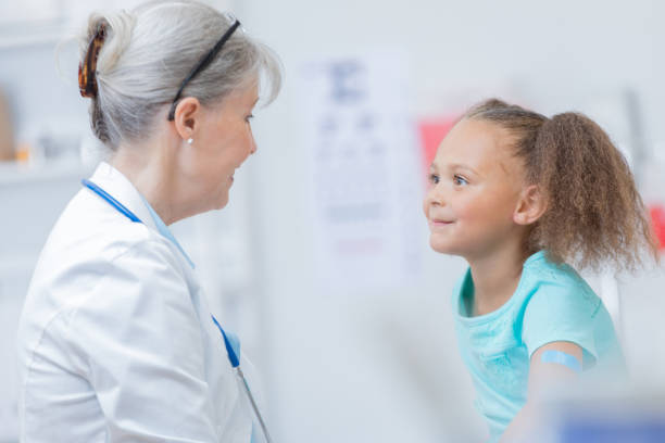 istock Confident pediatrician talks with young patient 817888786