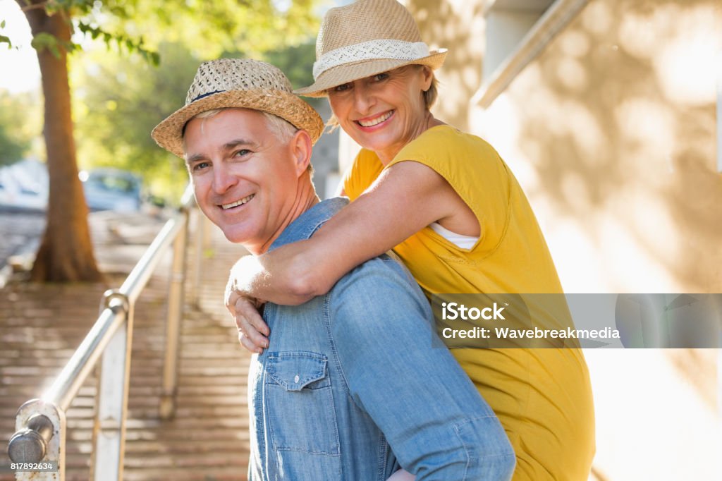 Happy mature couple having fun in the city Happy mature couple having fun in the city on a sunny day Mature Couple Stock Photo