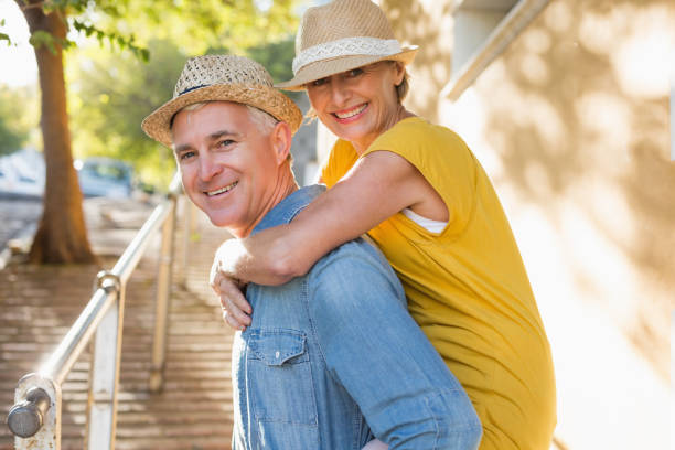 Happy mature couple having fun in the city Happy mature couple having fun in the city on a sunny day 50 59 years stock pictures, royalty-free photos & images