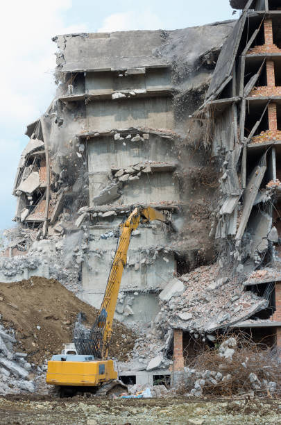 istock Heavy equipment being used to tear tearing down building construction 817940510