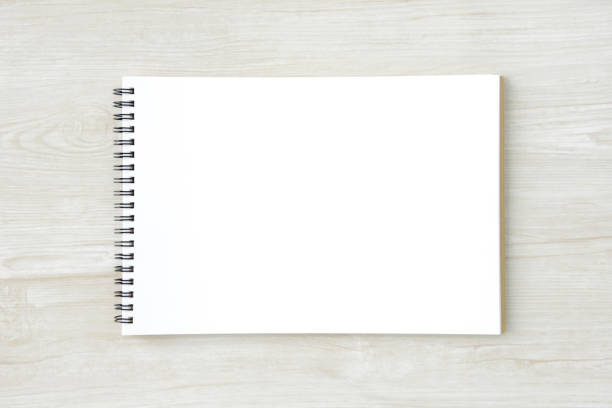 istock Sketchbook on white wooden board 817977384