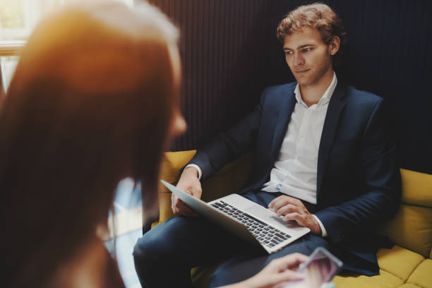 istock Boss with laptop and his co-worker in defocused foreground 817978878