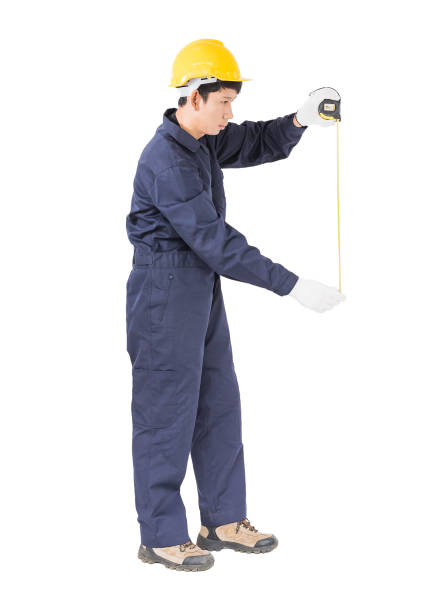 istock Young worker in unifrom with tape measure on white 817980064
