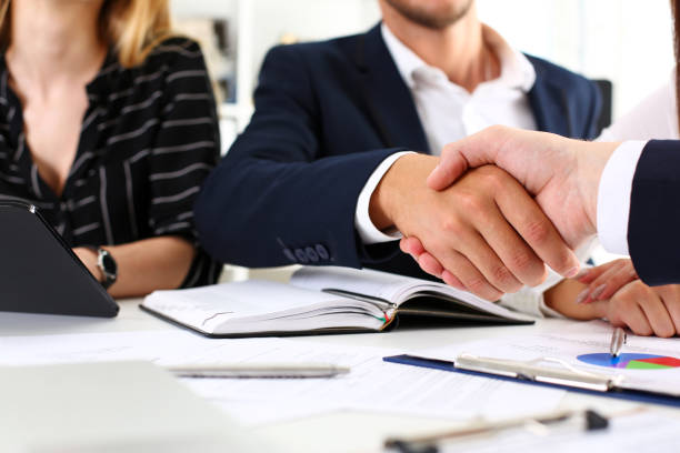 istock Man in suit shake hand as hello in office closeup 817984840