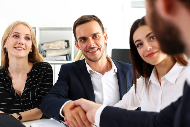 istock Smiling man in suit shake hands as hello in office 817984848