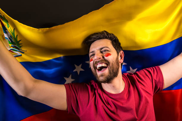 istock Venezuelan fan holding the national flag 817998986