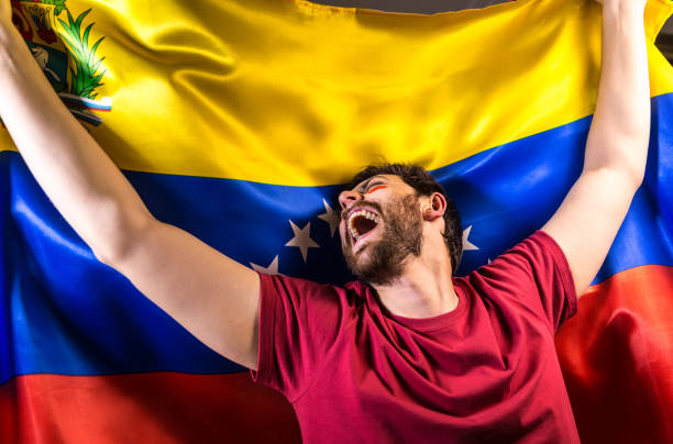 istock Venezuelan fan holding the national flag 817998992
