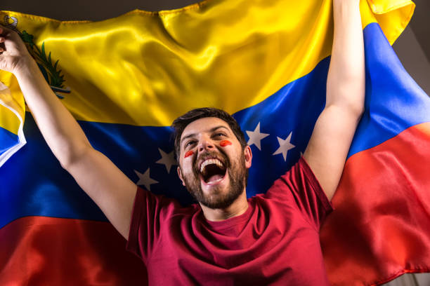 istock Venezuelan fan holding the national flag 817999036