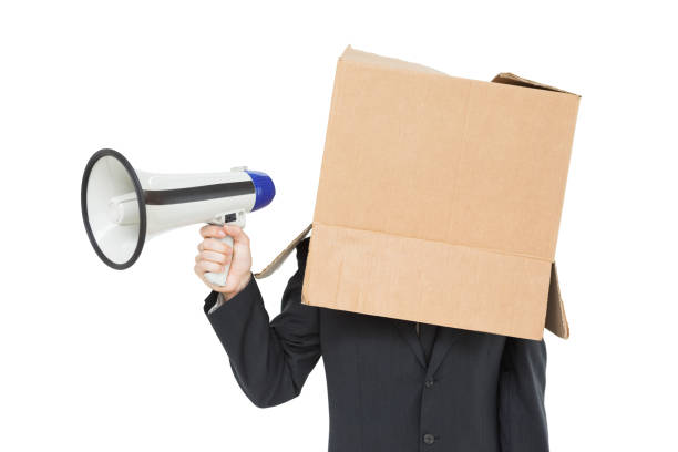 istock Businessman with box on head holding megaphone 817999492