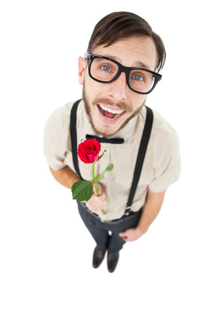 Geeky lovesick hipster holding rose on white background