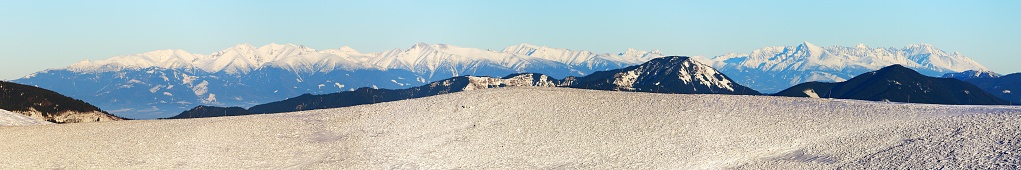 Panoramic wintry view from Velka Fatra mountains ridge to High Tatras mountains, Slovakia