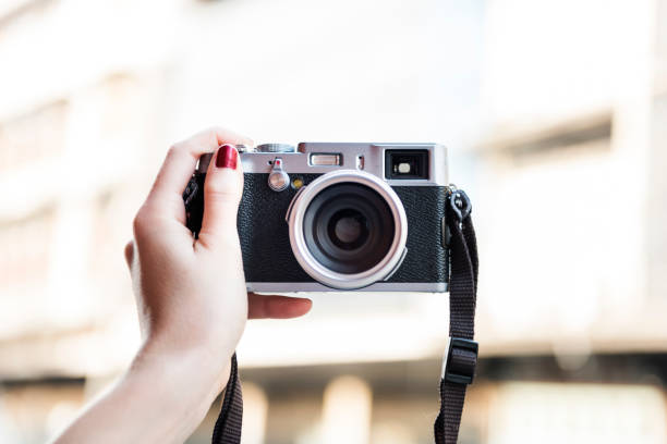 istock Hand Holding Carrying Camera Photograph Memory Concept 818064174