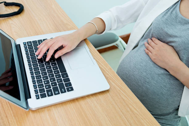 istock Pregnant woman working on laptop 818079214
